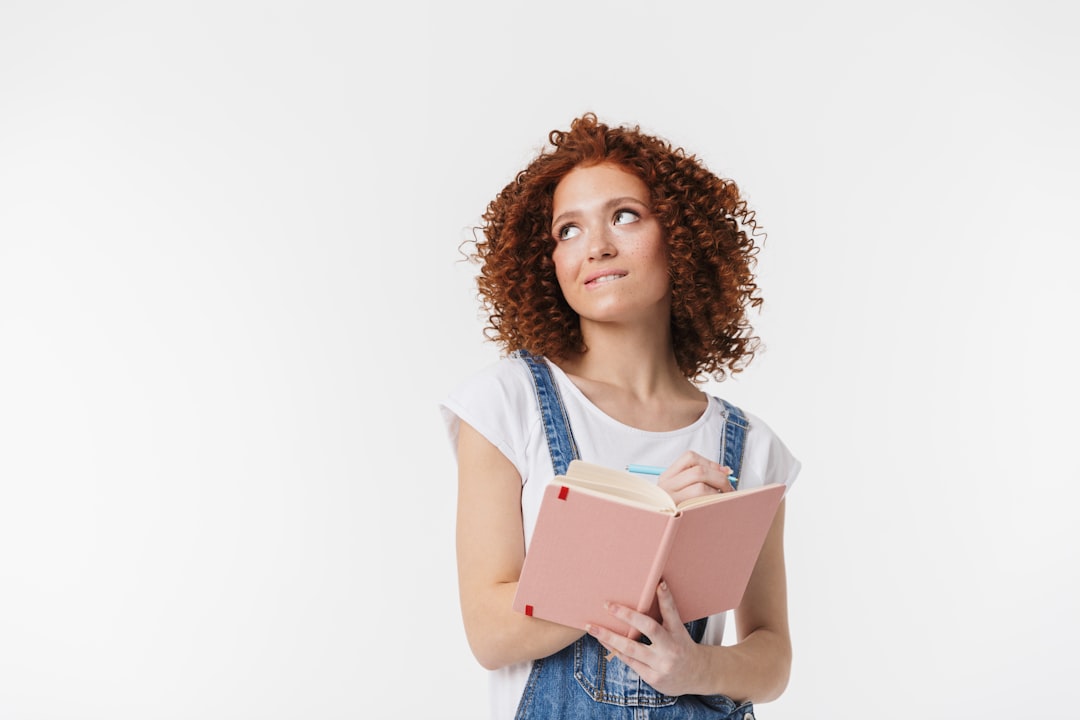 O nas a-woman-with-curly-hair-is-holding-a-book-3qpxlxac3-y